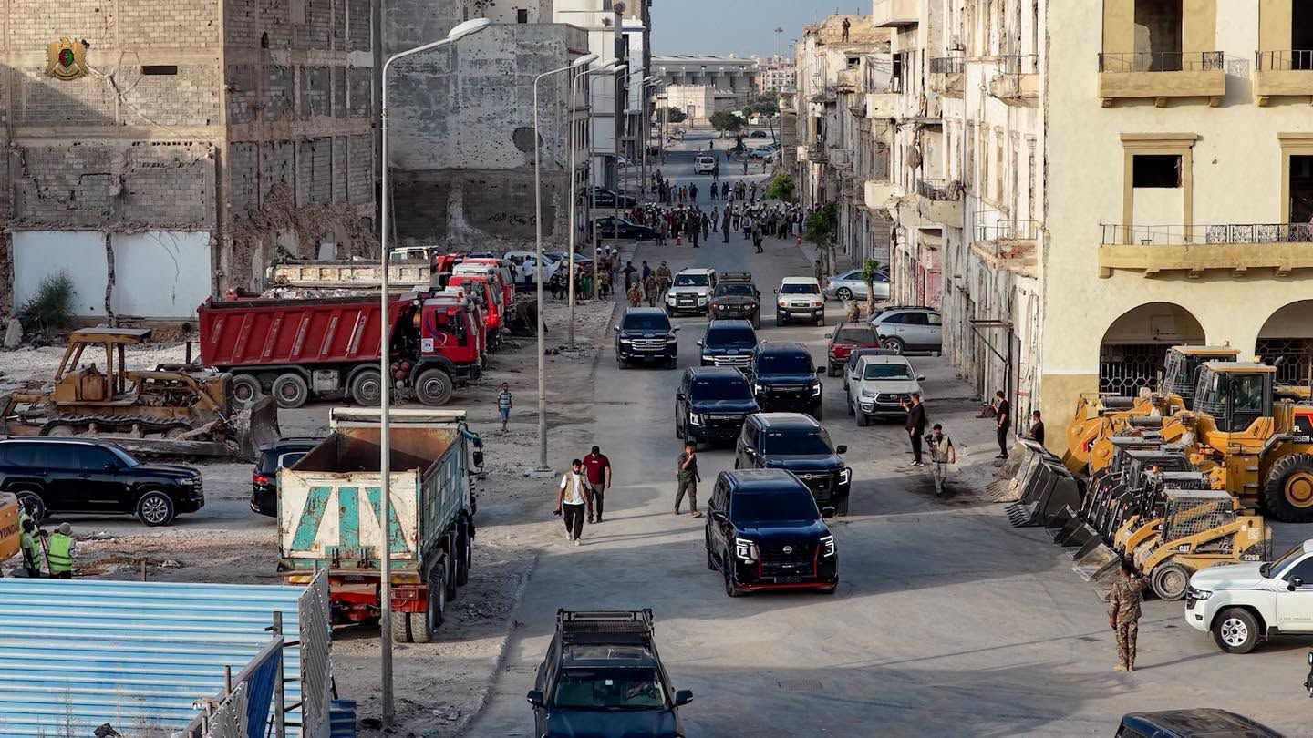 May be an image of one or more people, road and street